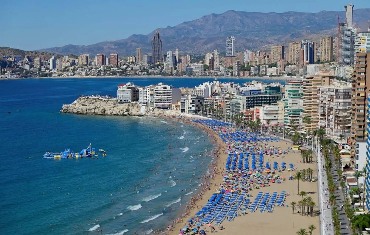 People enjoy the Levante Beach in Benidorm, north of Alicante, on September 11, 2025. (AFP)
