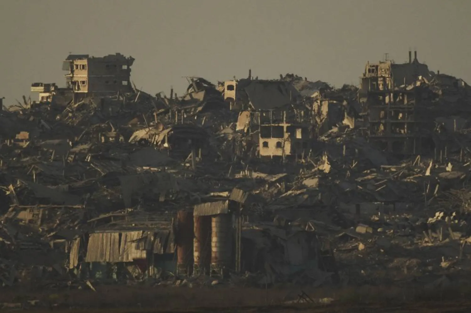 Buildings that were destroyed during the Israeli ground and air operations stand in the northern Gaza Strip during the sunset as seen from southern Israel, Tuesday, Sept. 16, 2025. (AP)