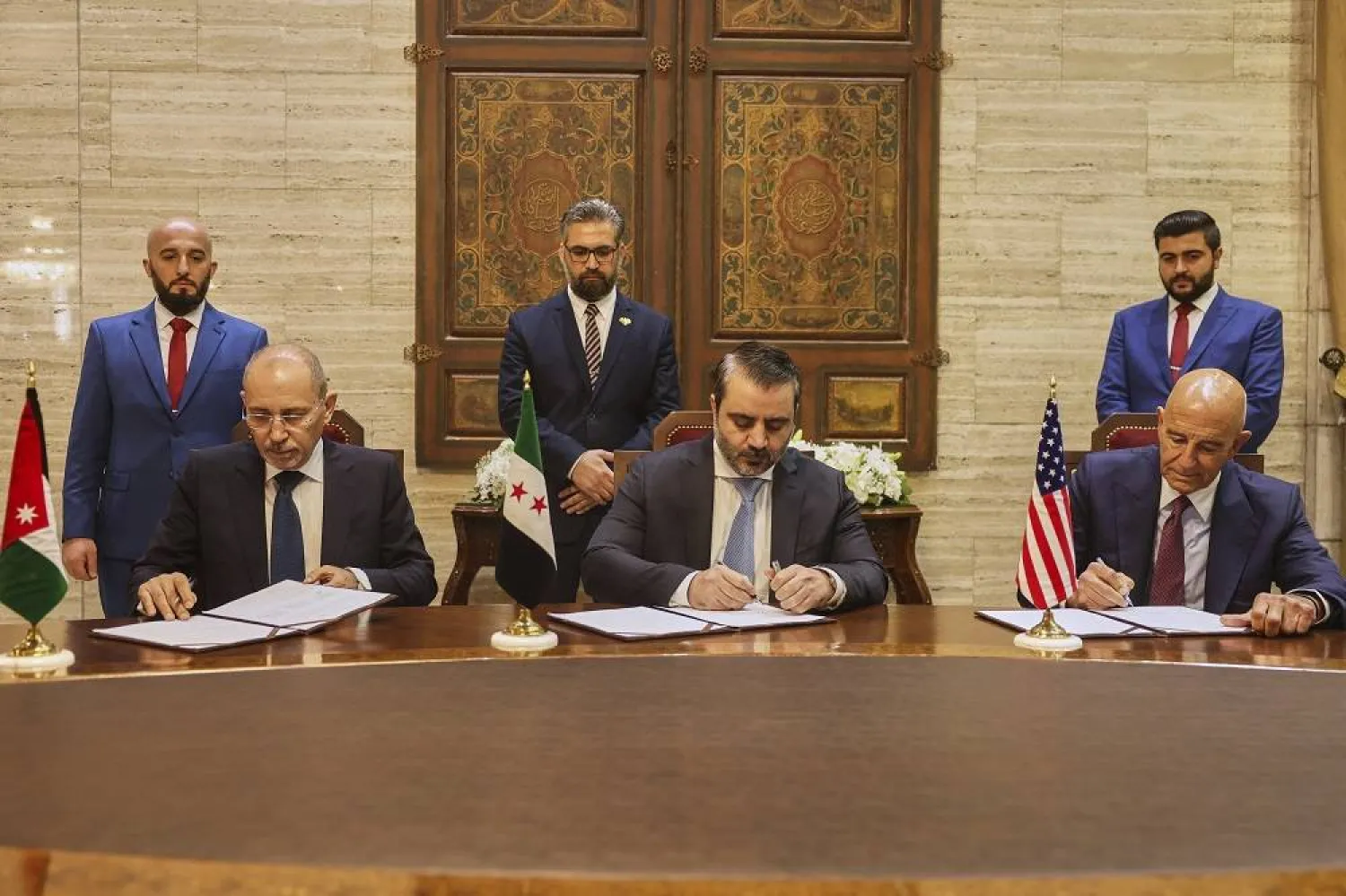 US Ambassador to Türkiye and Special Envoy to Syria Tom Barrack, right, Jordanian Foreign Minister Ayman Safadi, left, and Syrian Foreign Minister Asaad al-Shaibani sign a roadmap to restore security in southern Syria, in Damascus, Syria, Tuesday, Sept. 16, 2025. (AP) 