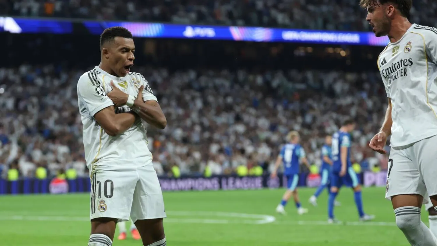 Kylian Mbappe celebrates his second penalty as Real Madrid came from behind to beat Marseille 2-1. Thomas COEX / AFP

