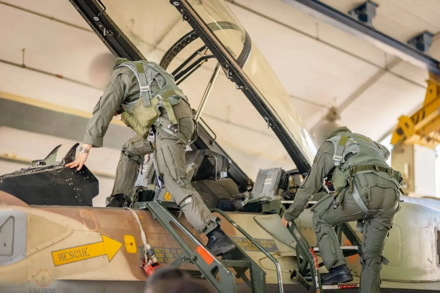 Two Israeli pilots board a warplane before its departure to carry out strikes on Iran. (Israeli army)