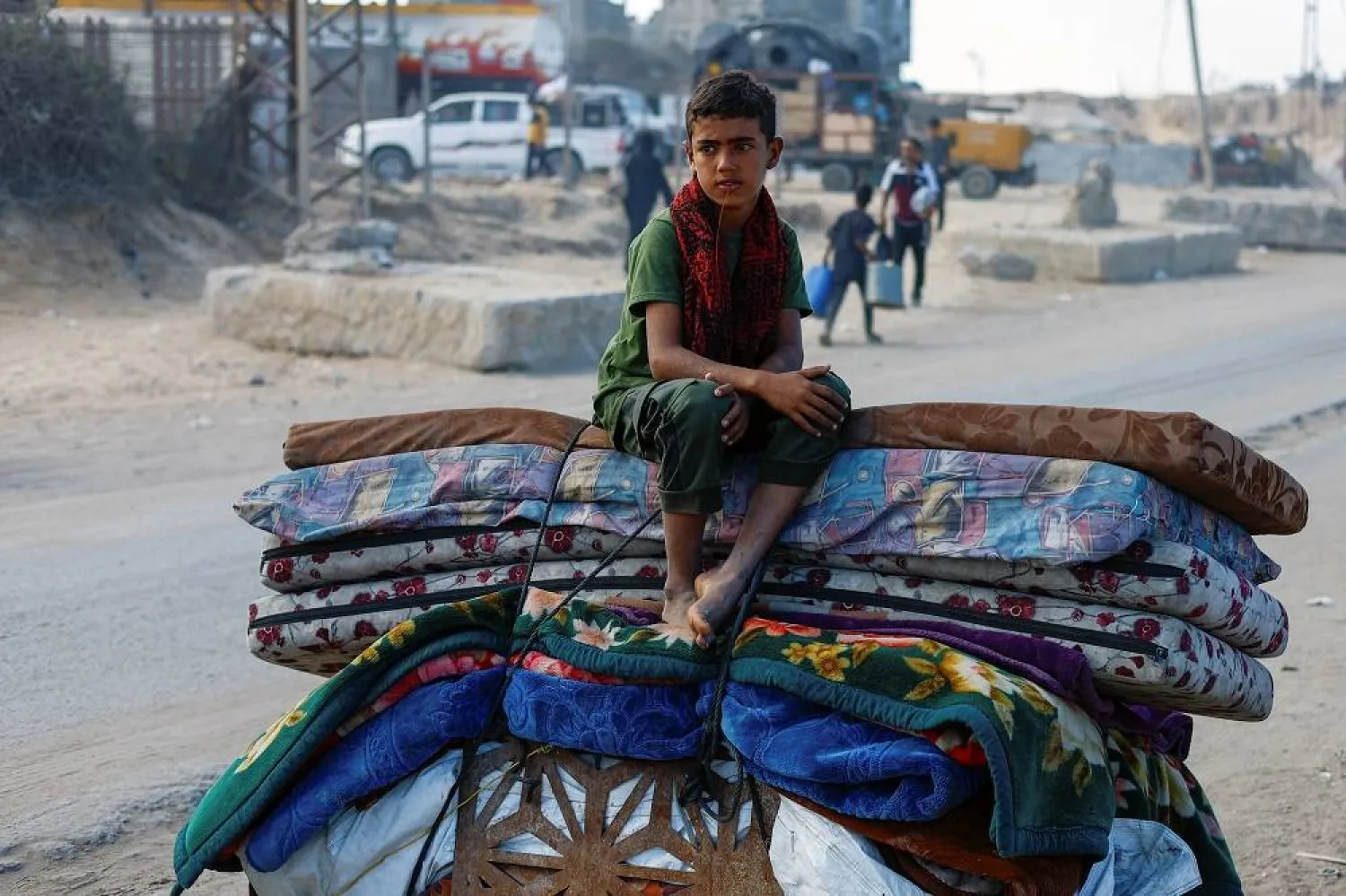 A displaced Palestinian boy, fleeing northern Gaza due to an Israeli military operation, sits atop belongings as he moves southward after Israeli forces ordered residents of Gaza City to evacuate to the south, in the central Gaza Strip September 17, 2025. (Reuters)
