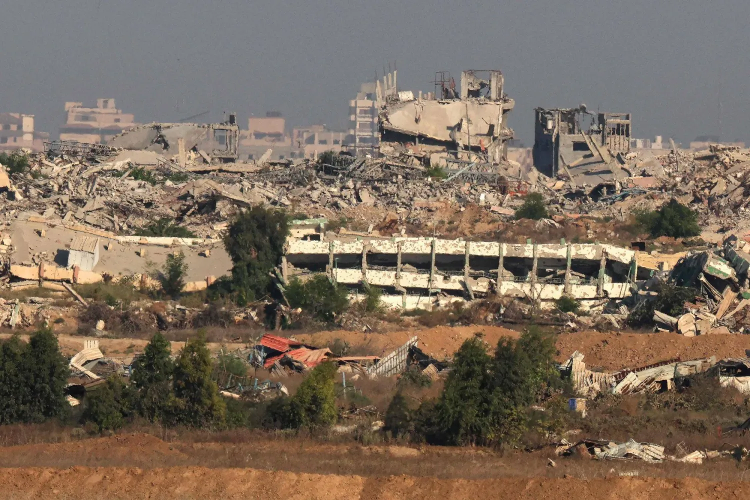 This picture taken from a position at Israel's border with the Gaza Strip shows destroyed buildings in the besieged Palestinian territory on September 17, 2025. (AFP)