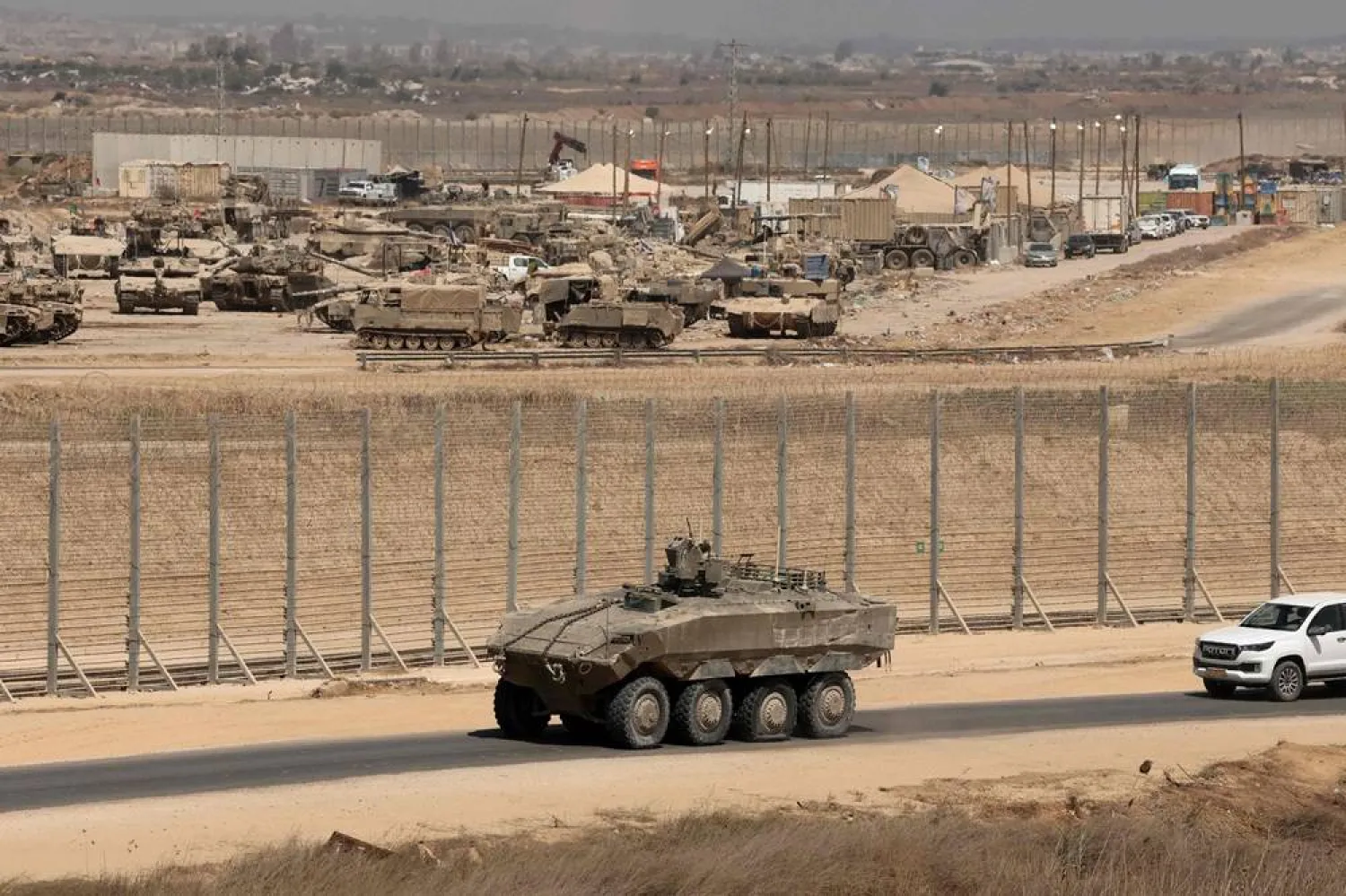 This picture taken from a position at Israel's border with the Gaza Strip shows Israeli troops deployed near the border fence with the besieged Palestinian territory on September 17, 2025. (AFP)
