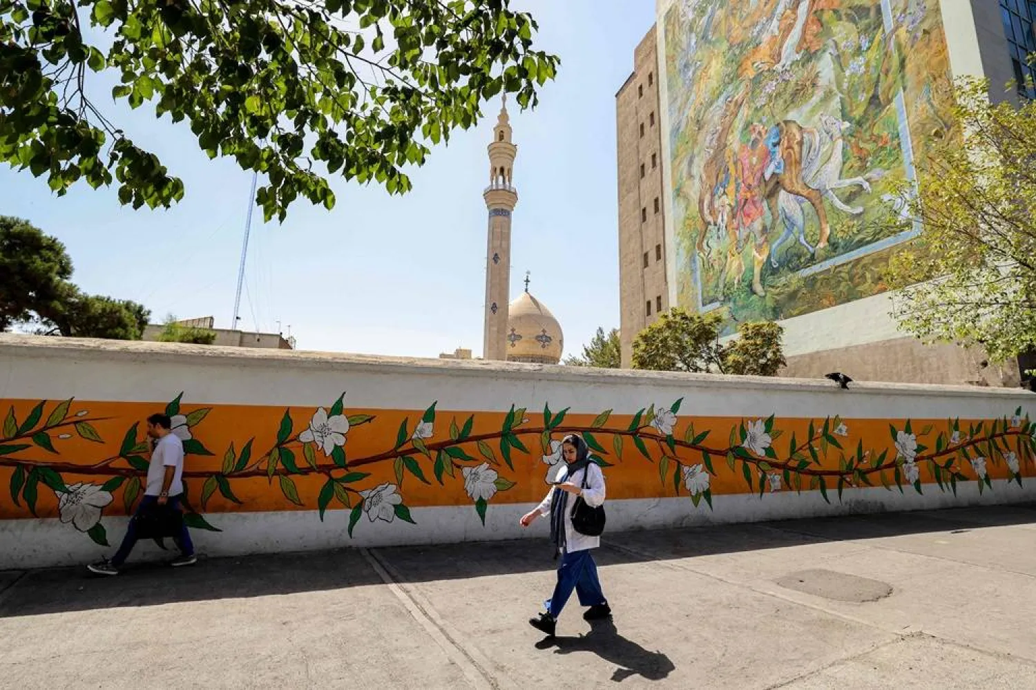 A woman walks along the side of a street in Tehran on September 15, 2025, a day ahead of the anniversary of the protest movement sparked by the death in custody of 22-year-old Iranian Mahsa Amini who was arrested for allegedly violating the dress code for women. (AFP)