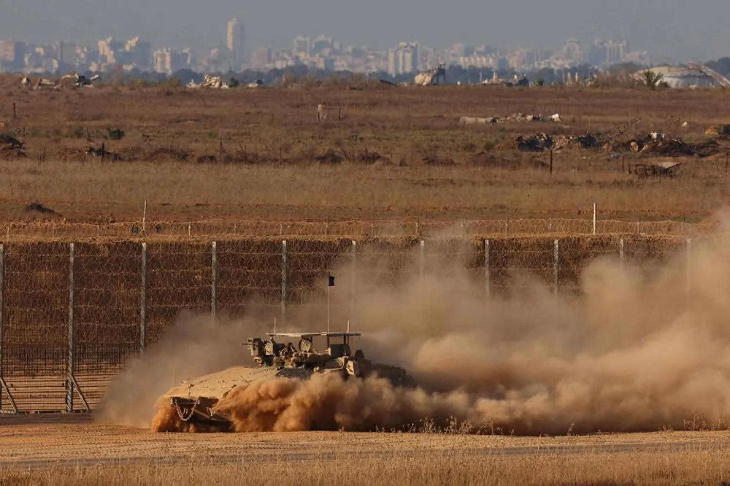 An Israeli military armored vehicle moves along the border fence with the Gaza Strip in southern Israel, on September 17, 2025. (AFP) 
