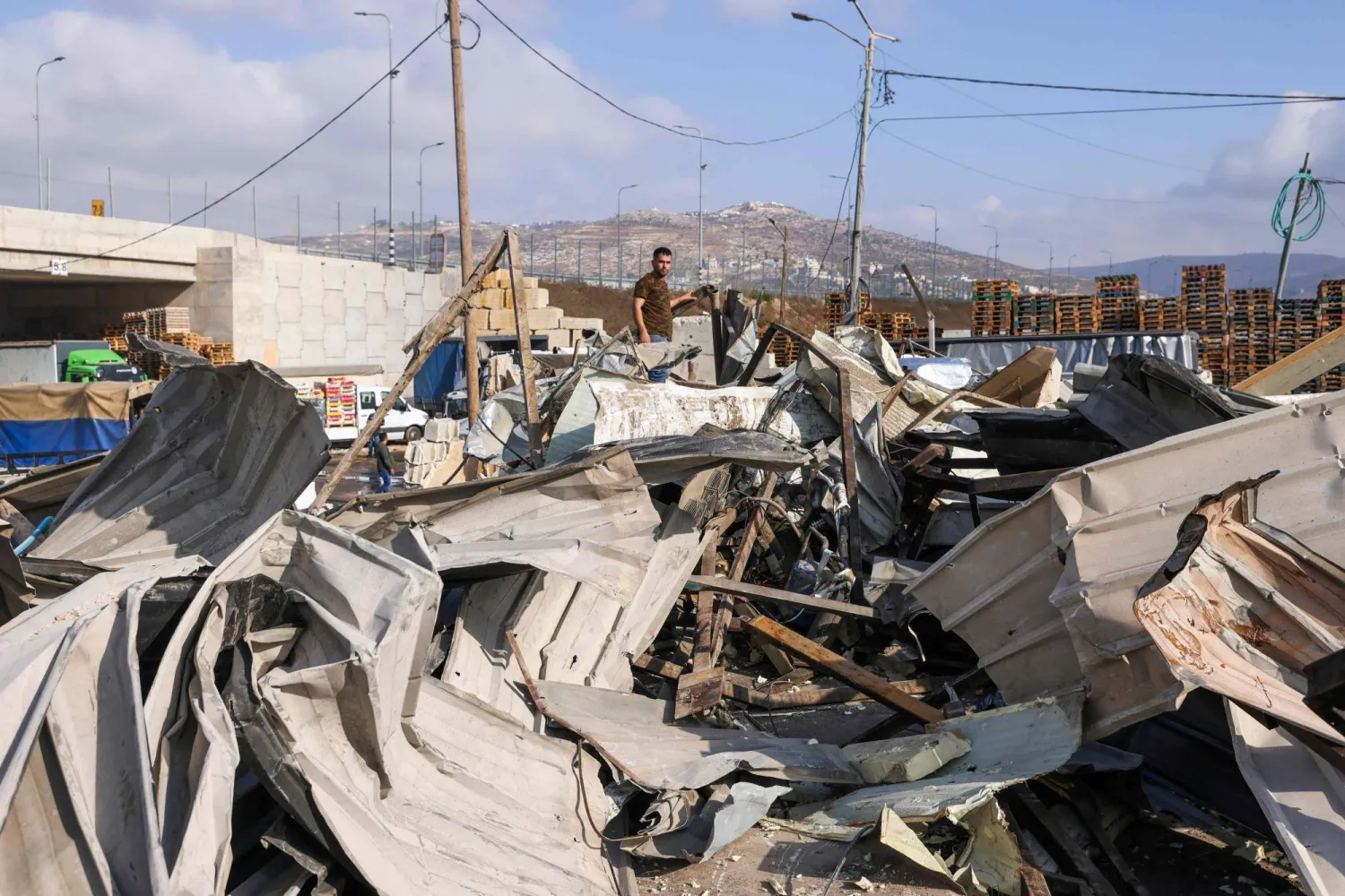 A Palestinian vendor inspects the rubble after the Israeli army demolished sixteen shops at the produce market in Beita village south of Nablus in the occupied West Bank on September 8, 2025. (Photo by JAAFAR ASHTIYEH / AFP)