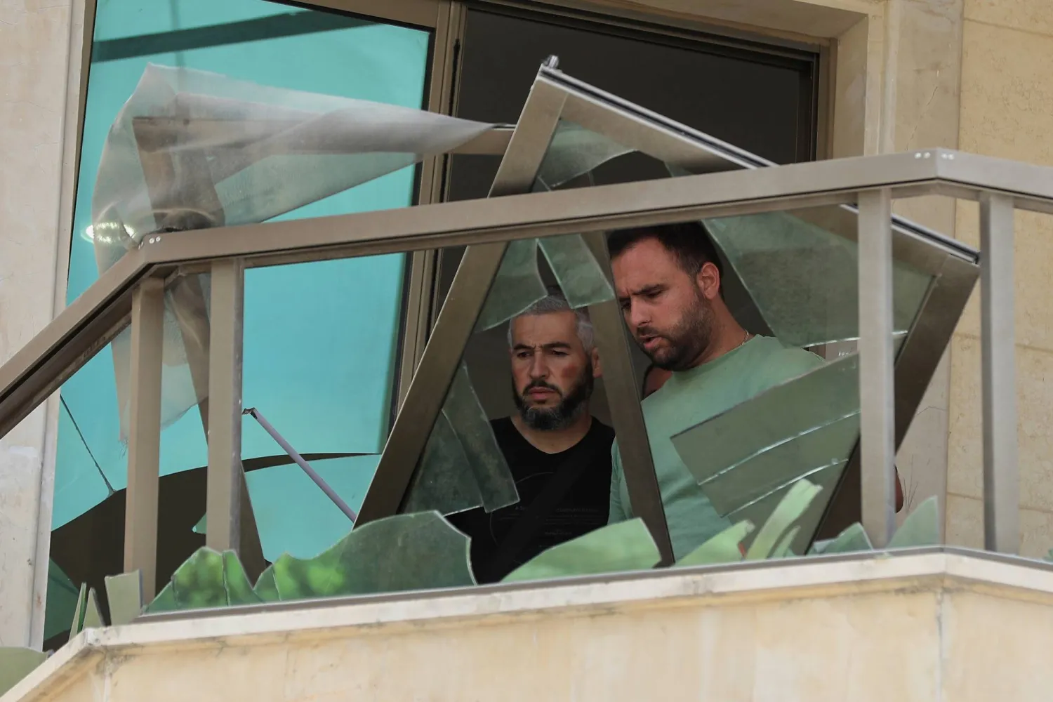 Residents check damage in an apartment that was hit in an Israeli airstrike on Monday evening, in Nabatiyeh town, south Lebanon Tuesday, Sept. 16, 2025. (AP Photo/Mohammad Zaatari)