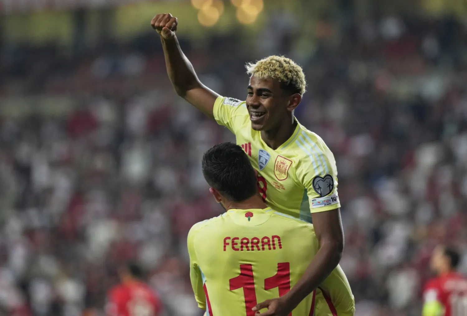 Spain's Ferran Torres, bottom, is congratulated by Lamine Yamal after scoring his side's 4th goal during a World Cup qualifying round Group E soccer match between Türkiye and Spain at Konya Buyuksehir stadium, in Konya, Türkiye, Sunday, Sept. 7, 2025. (AP Photo/Khalil Hamra)
