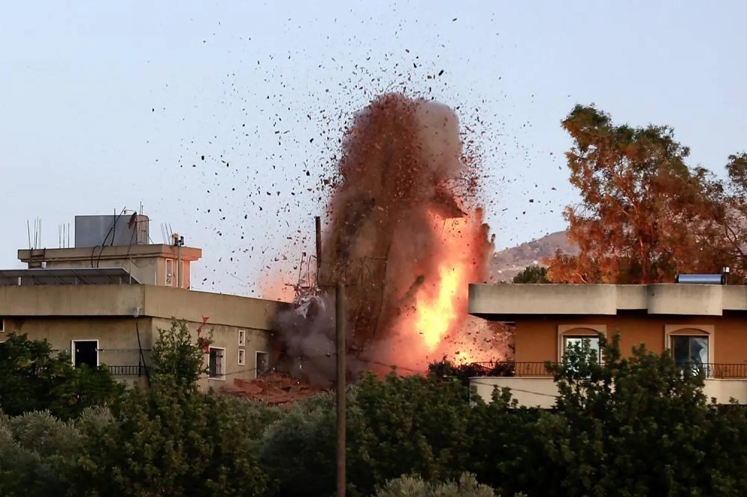 Flames and debris following an Israeli airstrike in the village of Kfar Tebnit, southern Lebanon, 18 September 2025. (EPA)