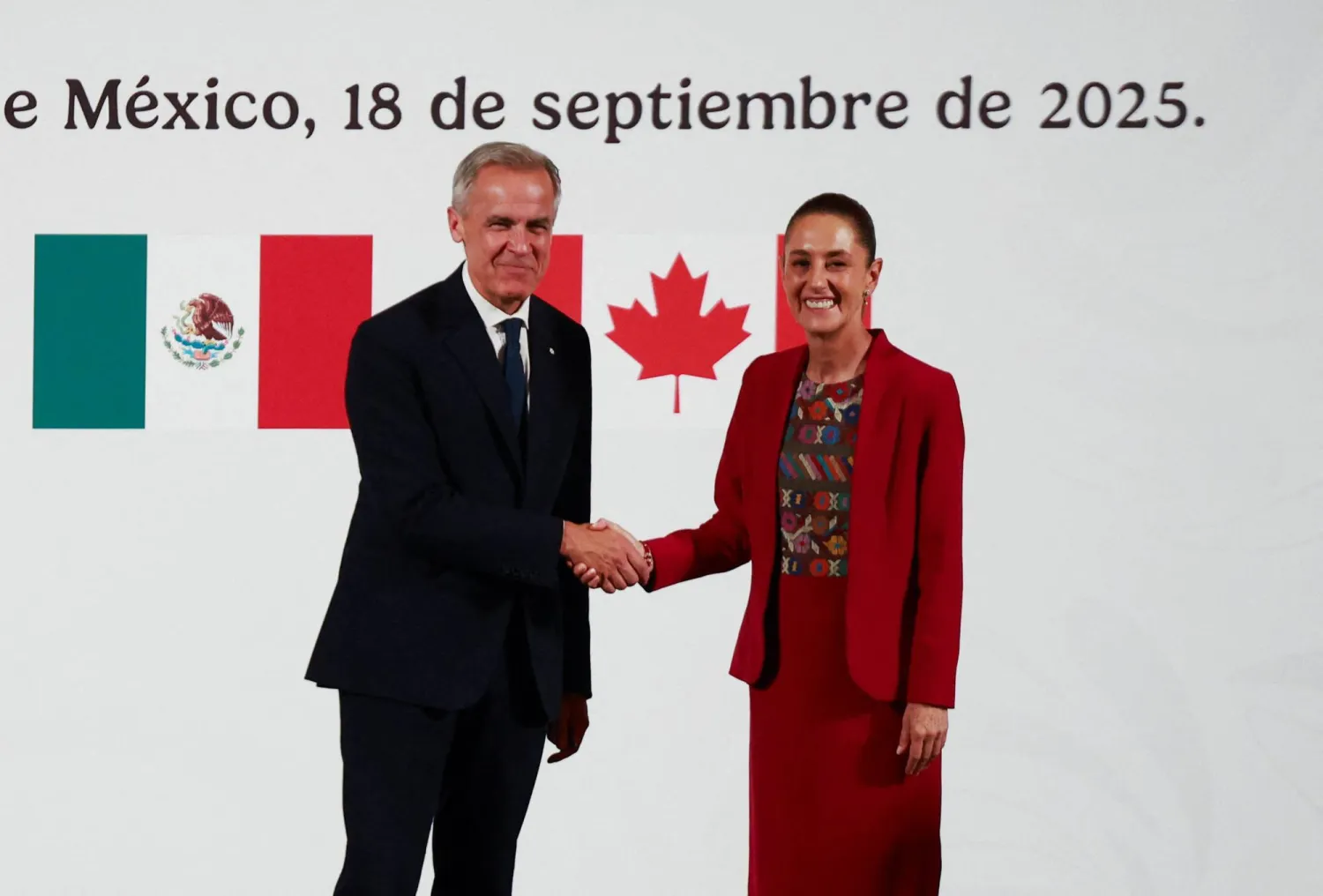 Mexican President Claudia Sheinbaum and Canadian Prime Minister Mark Carney shake hands as they hold a press conference at the National Palace, in Mexico City, Mexico September 18, 2025. (Reuters)