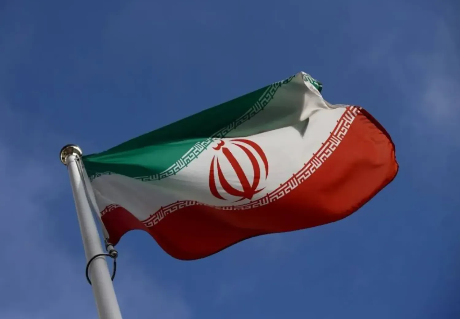 The Iranian flag waves in front of the International Atomic Energy Agency (IAEA) headquarters, before the beginning of a board of governors meeting, amid the coronavirus disease (COVID-19) outbreak in Vienna, Austria, March 1, 2021. (Reuters)
