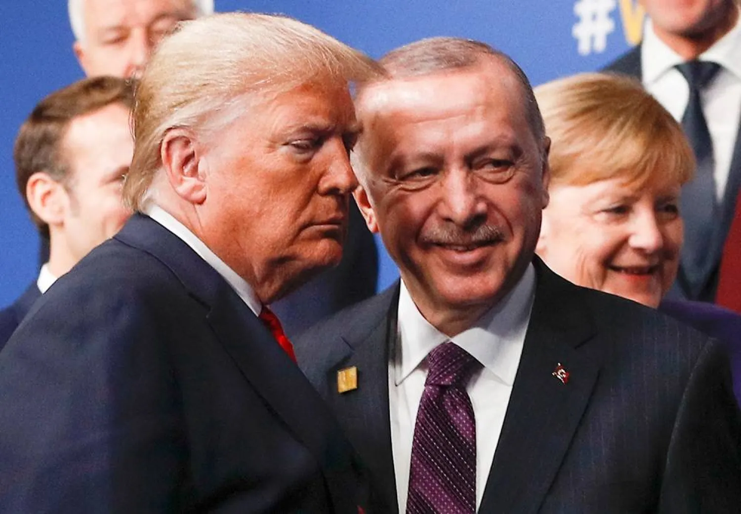 US President Donald Trump (L) and Turkey's President Recep Tayyip Erdogan (R) leave the stage after the family photo to head to the plenary session at the NATO summit at the Grove hotel in Watford, northeast of London on December 4, 2019. (AFP)