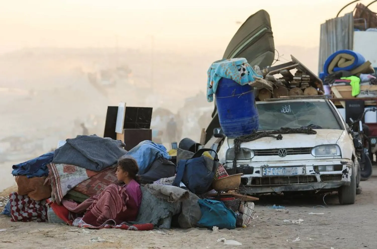  A displaced Palestinian girl, fleeing northern Gaza due to an Israeli military operation, sits next to belongings as people move southwards after Israeli forces ordered residents of Gaza City to evacuate to the south, in the central Gaza Strip, September 20, 2025. (Reuters)