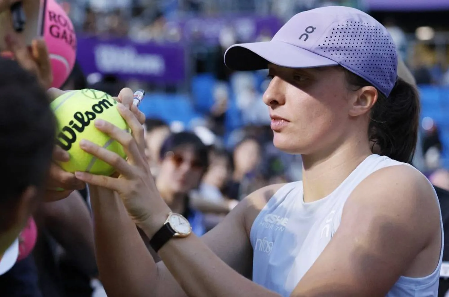 WTA 500 - Korea Open - Olympic Park Tennis Center, Seoul, South Korea - September 20, 2025 Poland's Iga Swiatek signs autographs after winning her semifinal match against Australia's Maya Joint. (Reuters)