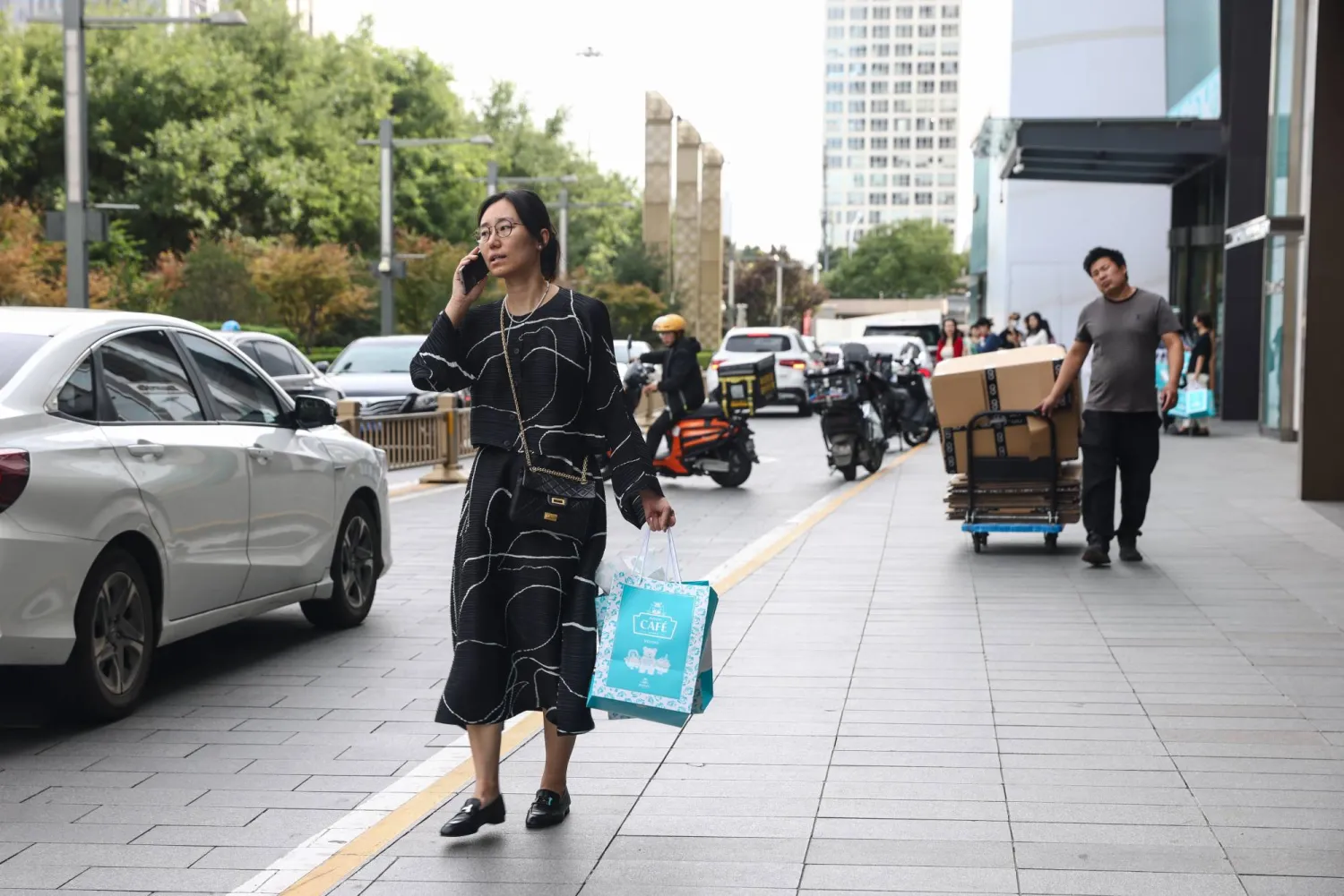 People walk on a street in the Central Business District (CBD) area in Beijing, China, 20 September 2025.  EPA/WU HAO
