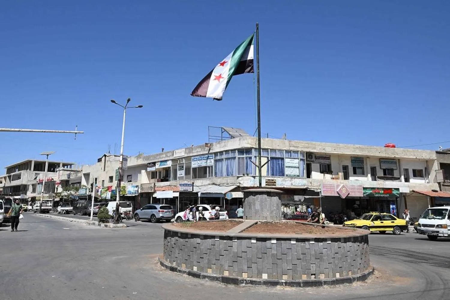 This picture shows a Syrian national flag fluttering at the Khan Arnabeh area in the city of Quneitra near the border with Israel in southern Syria on September 21, 2025. (AFP)