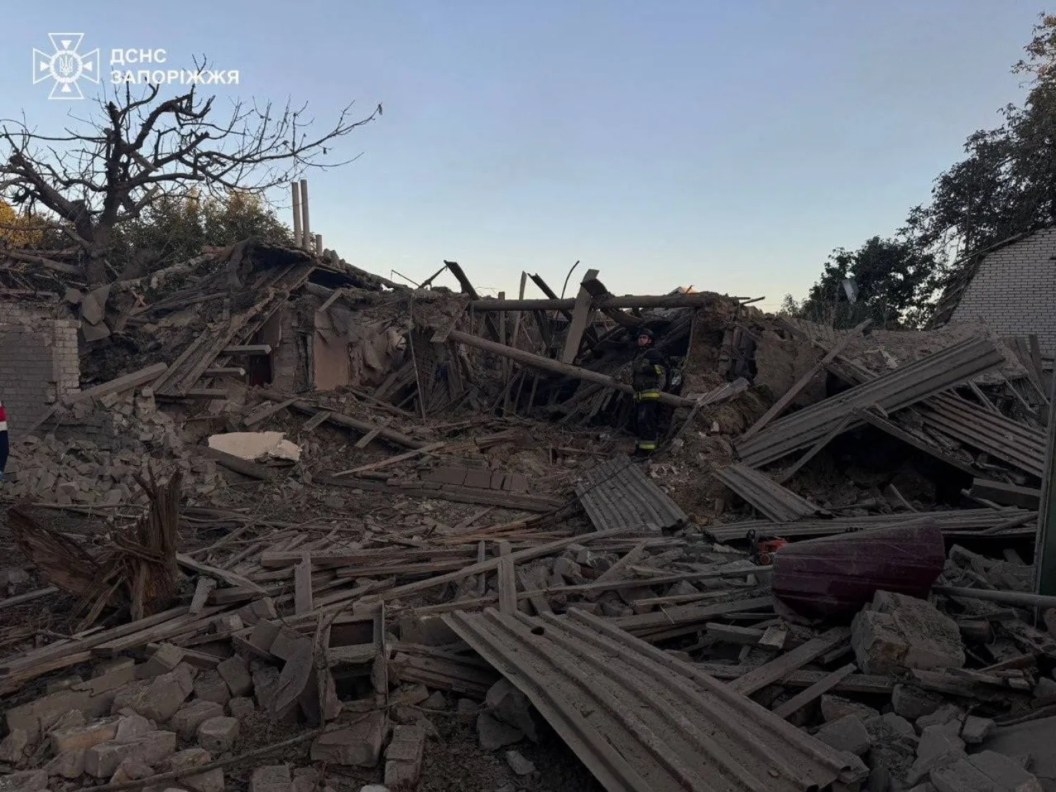 A rescuer works at the site of a residential building which was hit during a Russian air strike, amid Russia's attack on Ukraine, in Zaporizhzhia, Ukraine September 22, 2025. (Press service of the State Emergency Service of Ukraine in Zaporizhzhia region/Handout via Reuters)