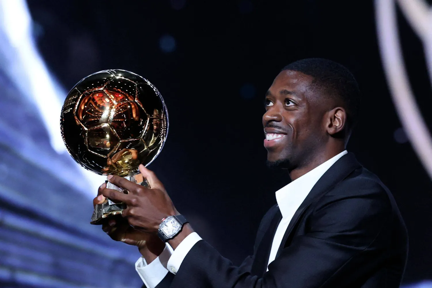 Paris Saint-Germain's French forward Ousmane Dembele reacts receiving the Ballon d'Or award from Brazilian former football player Ronaldinho (L) during the 2025 Ballon d'Or France Football award ceremony at the Theatre du Chatelet in Paris on September 22, 2025. (Photo by Franck FIFE / AFP)