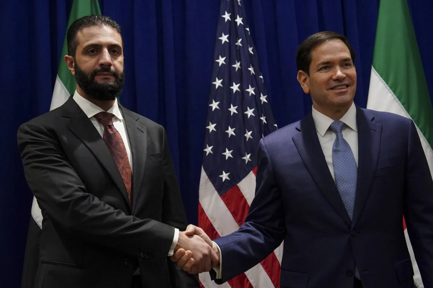 Secretary of State Marco Rubio shakes hands with Syrian interim President Ahmad al-Sharaa at the Lotte New York Palace Hotel, on the sidelines of the 80th United Nations General Assembly at the United Nations headquarters, Monday, Sept. 22, 2025. (Bing Guan/Pool Photo via AP)
