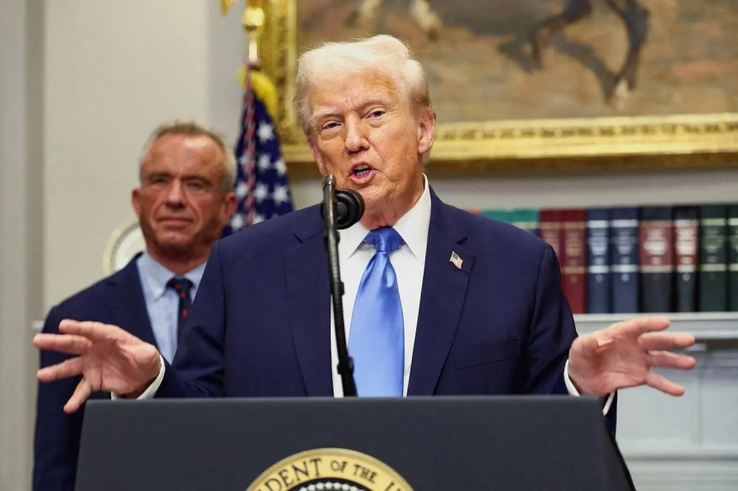 US President Donald Trump, in front of US Secretary of Health and Human Services Robert F. Kennedy Jr., delivers remarks linking autism to childhood vaccines and to the use of popular pain medication Tylenol for pregnant women and children, claims which are not backed by decades of science, at the White House in Washington, DC, US, September 22, 2025. (Reuters) 