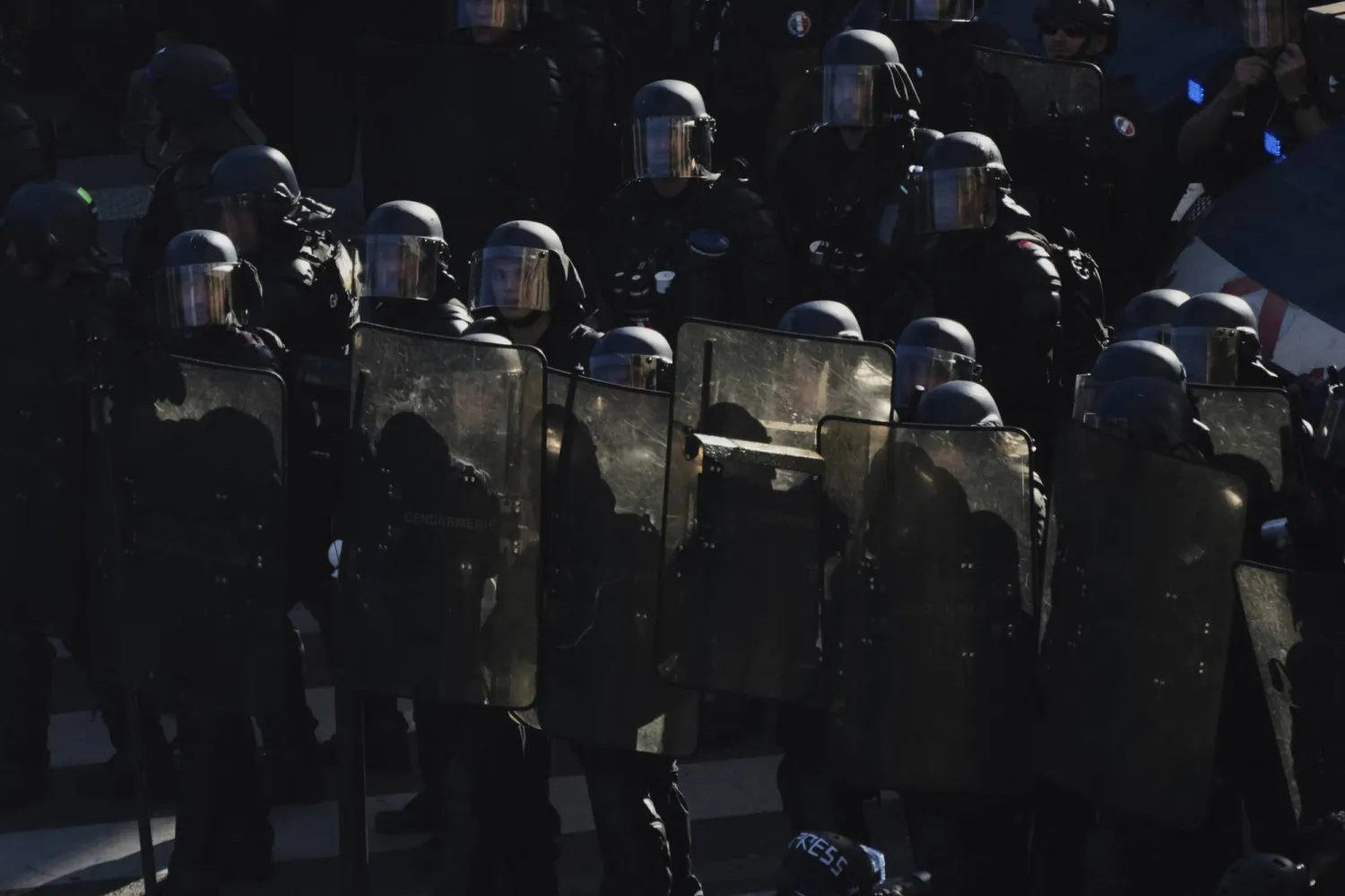 Police officers stand guard during a demonstration called by major trade unions to oppose budget cuts, in Paris, France, Thursday, Sept. 18, 2025. (AP Photo/Aurelien Morissard)