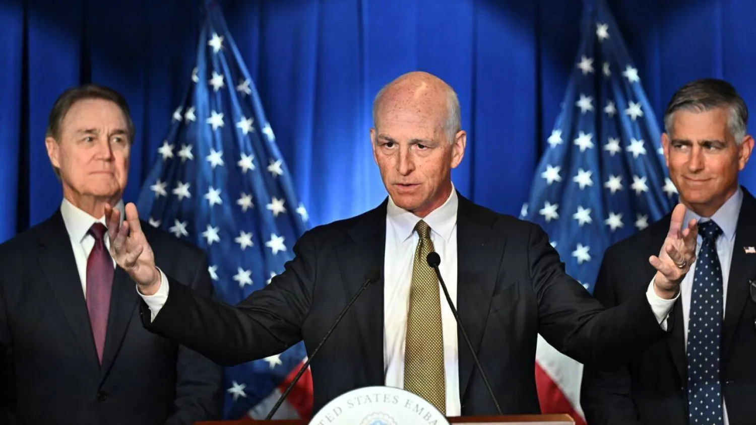 US Representative Adam Smith, flanked by US Ambassador to China David Perdue (left) and Michael Baumgartner, Republican member of House Foreign Affairs Committee during a press conference at the US embassy in Beijing. Pedro PARDO / AFP
