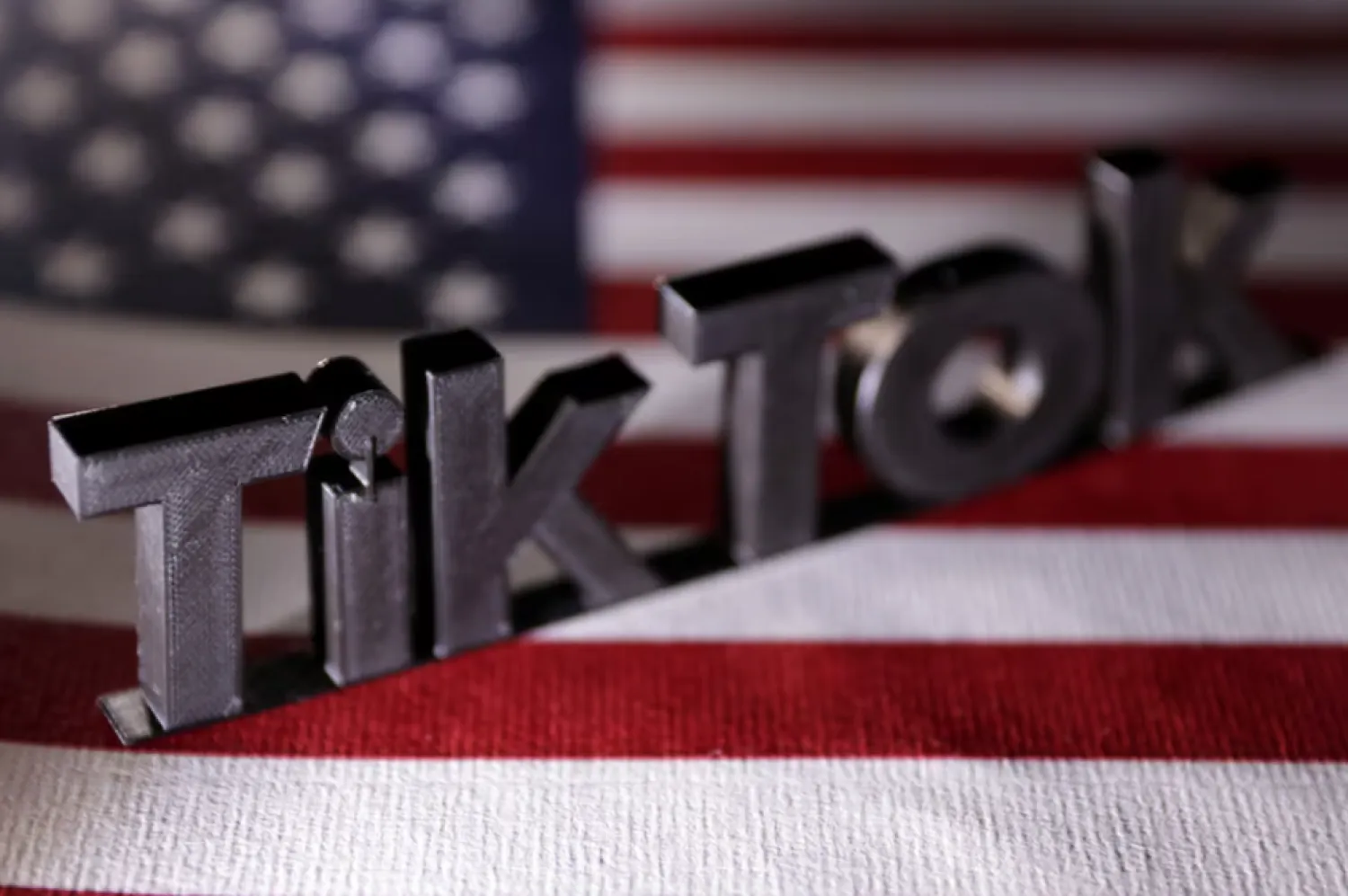 TikTok logo is placed on a US flag in this illustration taken, April 25, 2024. REUTERS/Dado Ruvic/Illustration/File Photo 