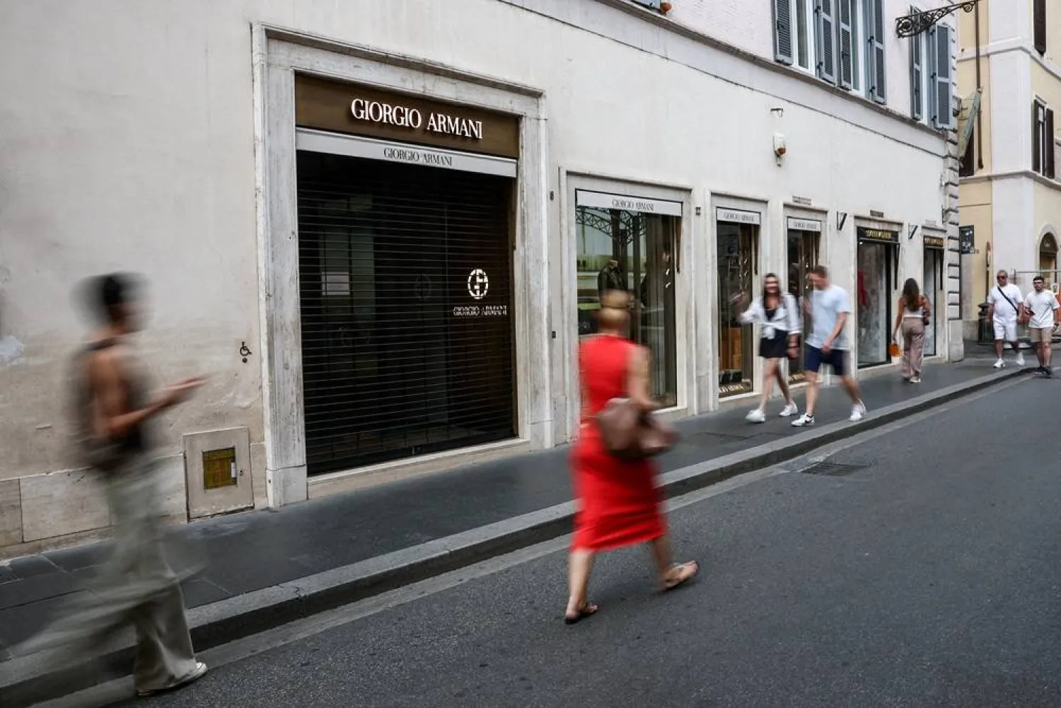 People walk past a closed Giorgio Armani store as it closes for mourning on the day of the Italian fashion designer’s funeral, in Rome, Italy September 8, 2025. (Reuters)