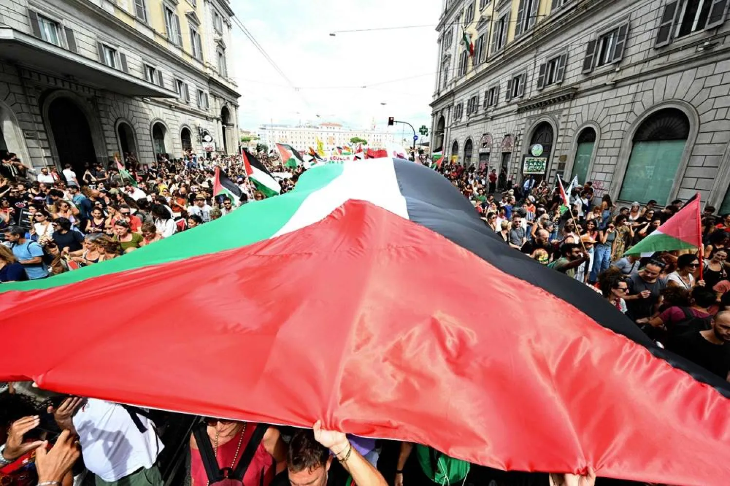 People march with a giant Palestinian flag during a nationwide strike "Let's Block Everything" in solidarity with Palestinians in Gaza and calling for a halt to arms shipments to Israel, in Rome on September 22. (AFP)