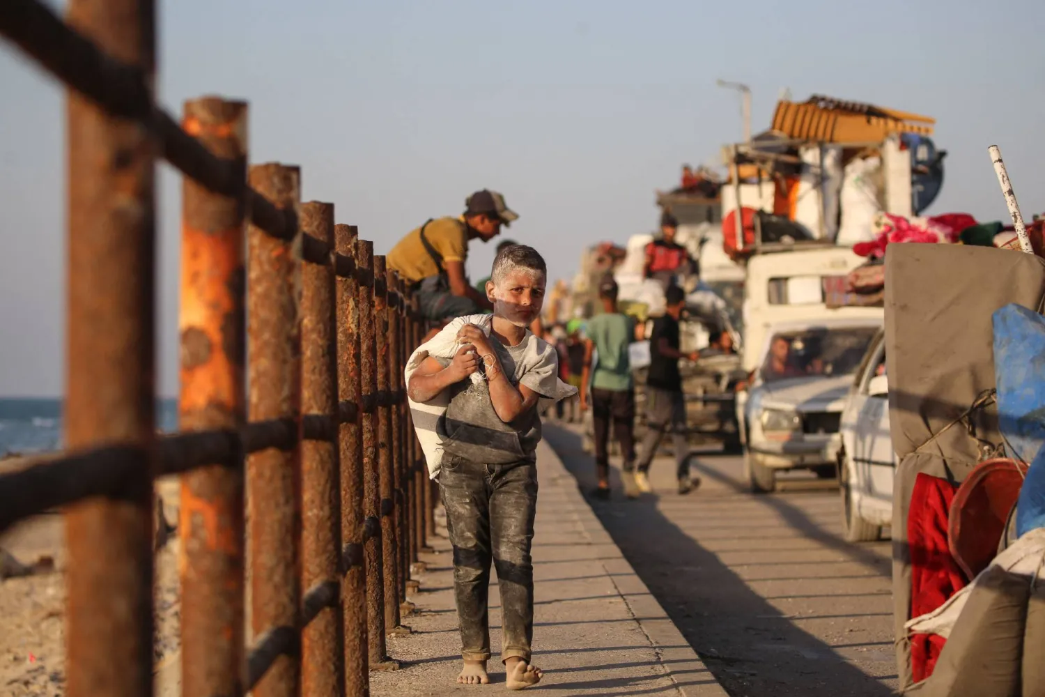 Displaced Palestinians move with their belongings southwards on a road in the Nuseirat refugee camp area in the central Gaza Strip on September 23, 2025, as Israel presses its ground offensive to capture Gaza City amidst the war against Hamas. (AFP)