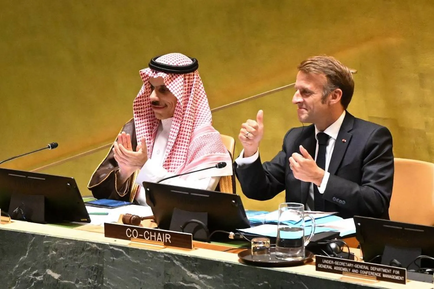 President of France Emmanuel Macron (R) and Saudi Foreign Minister Prince Faisal bin Farhan bin Abdullah (L) gesture during the High-Level International Conference for the Peaceful Settlement of the Question of Palestine and the Implementation of the Two-State Solution, at the United Nations (UN) headquarters in New York, New York, USA, 22 September 2025. (EPA) 