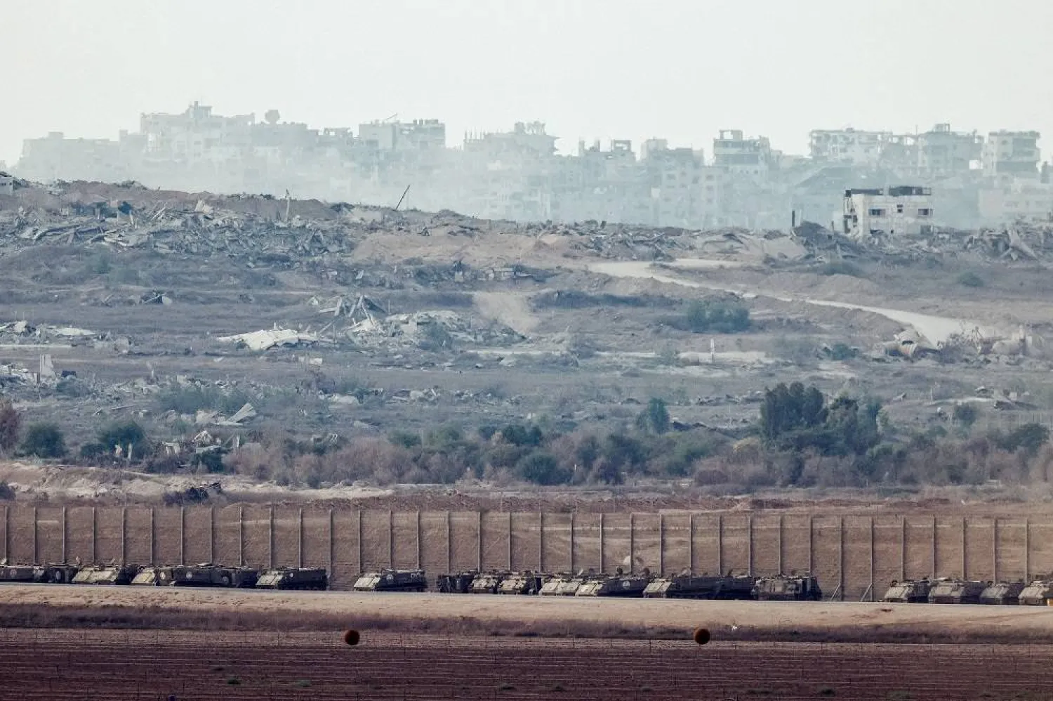 Armored personnel carriers (APCs) are aligned on the Israeli side of the border with Gaza, in Israel, September 23, 2025. (Reuters)