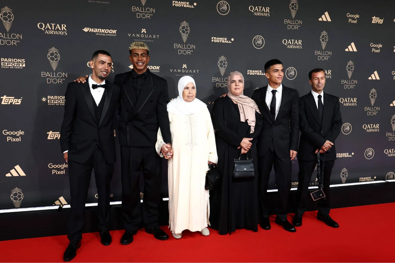Barcelona's Spanish forward Lamine Yamal (2nd L) and his family pose upon arrival before the 2025 Ballon d'Or France Football award ceremony at the Theatre du Chatelet in Paris on September 22, 2025. (AFP) 