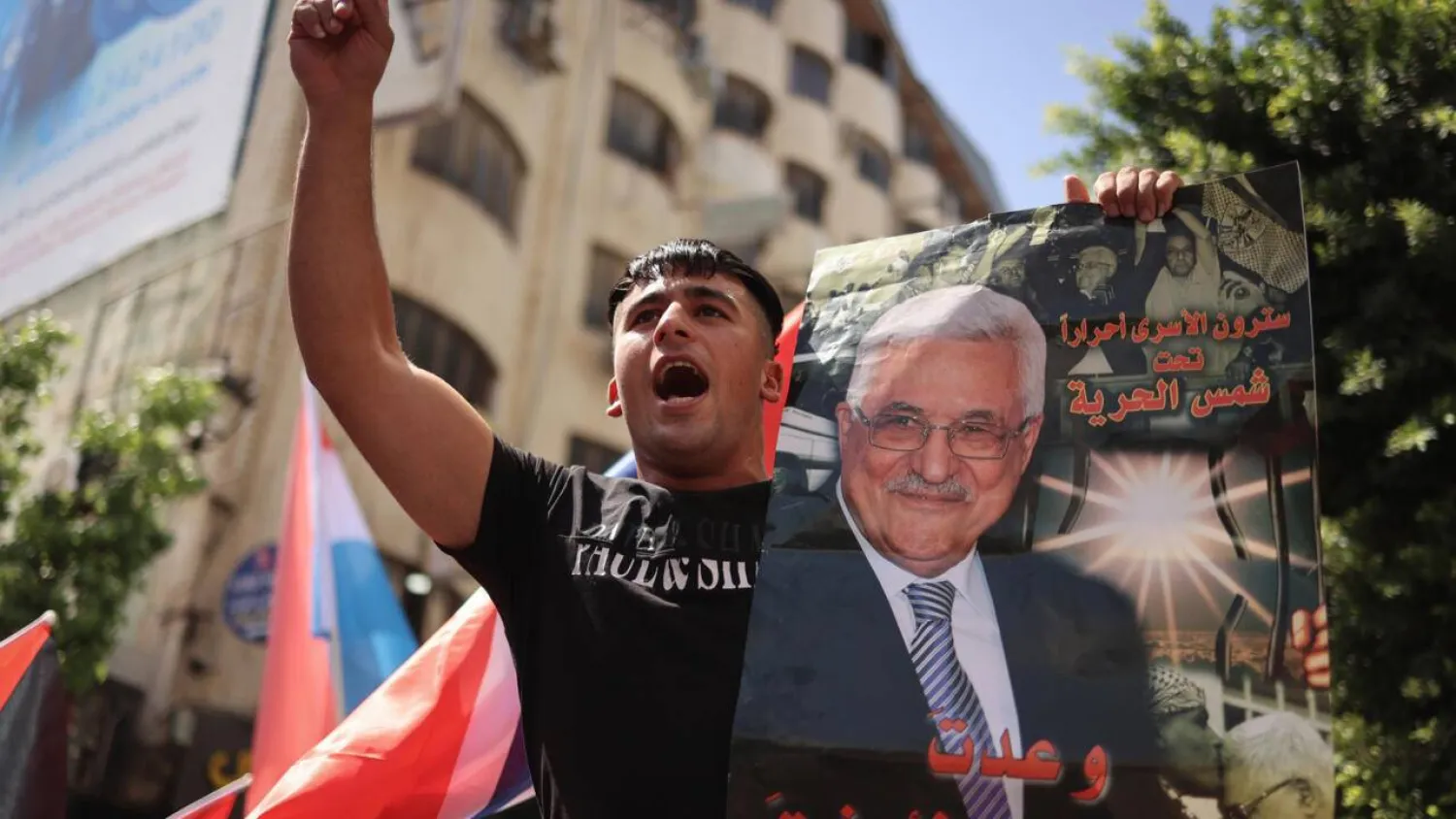 A Palestinian chants slogans in Ramallah while holding a portrait of Palestinian Authority president Mahmud Abbas. Zain JAAFAR / AFP
