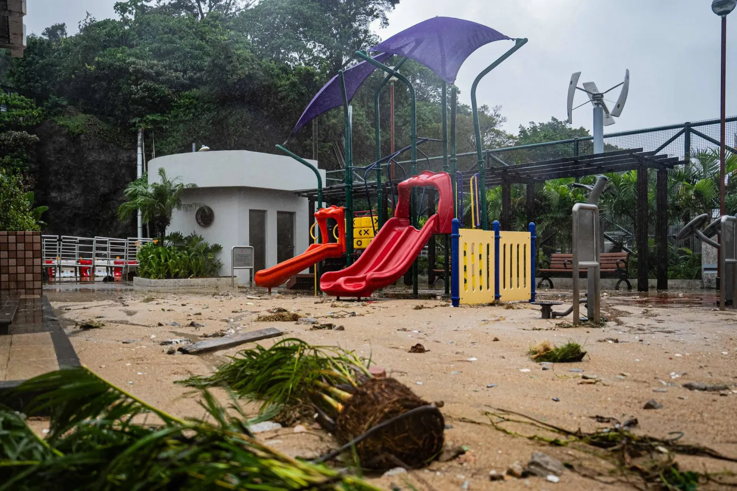 Sand and debris washed away during earlier flooding cover a park in Lei Yue Mun after Super Typhoon Ragasa hit Hong Kong on September 24, 2025. (Photo by Leung Man Hei / AFP)
