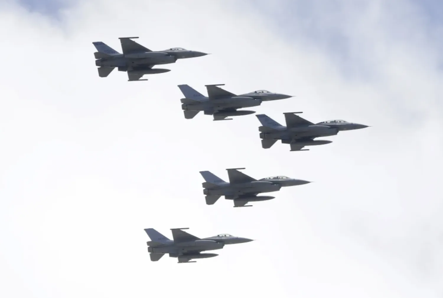 FILE - Taiwan’s F-16 fighter jets fly in close formation over President Office during National Day celebrations in front of the Presidential Building in Taipei, Taiwan, Oct. 10, 2021. (AP Photo/Chiang Ying-ying, File)

