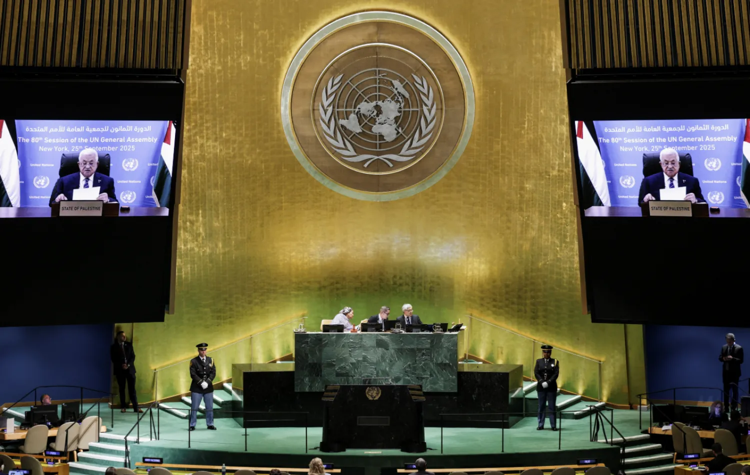 Palestinian President Mahmoud Abbas appears on screens as he addresses UNGA, New York, US, September 25, 2025. REUTERS/Jeenah Moon
