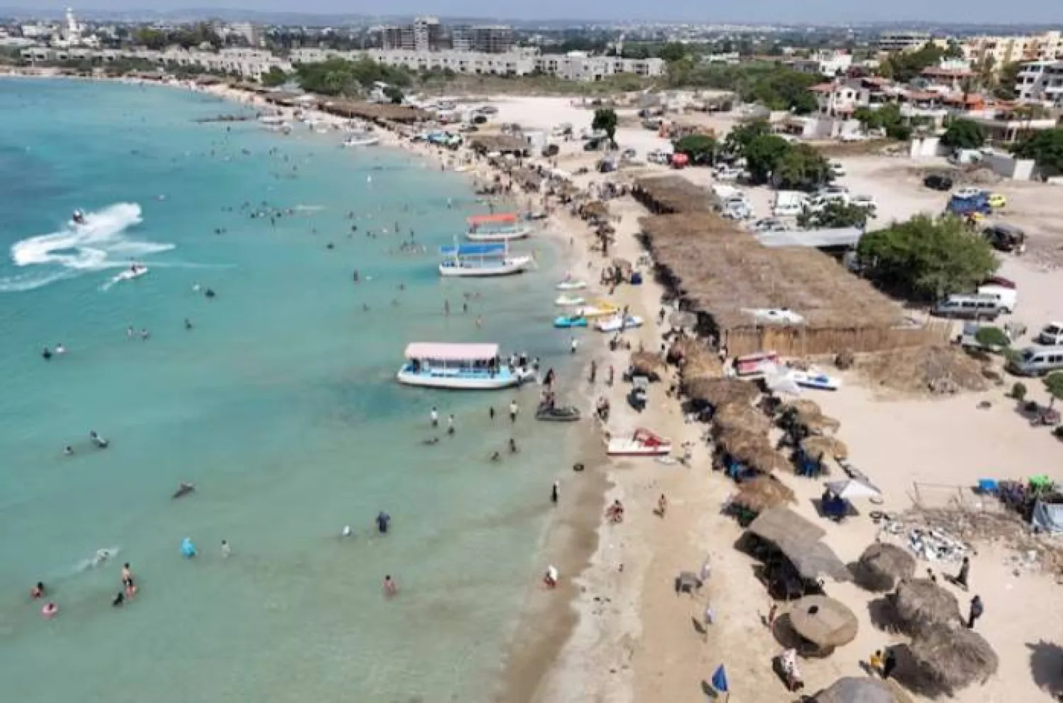 A drone view shows people swimming at a public beach in Latakia, Syria June 12, 2025. REUTERS/Karam Al-Masri/File Photo 