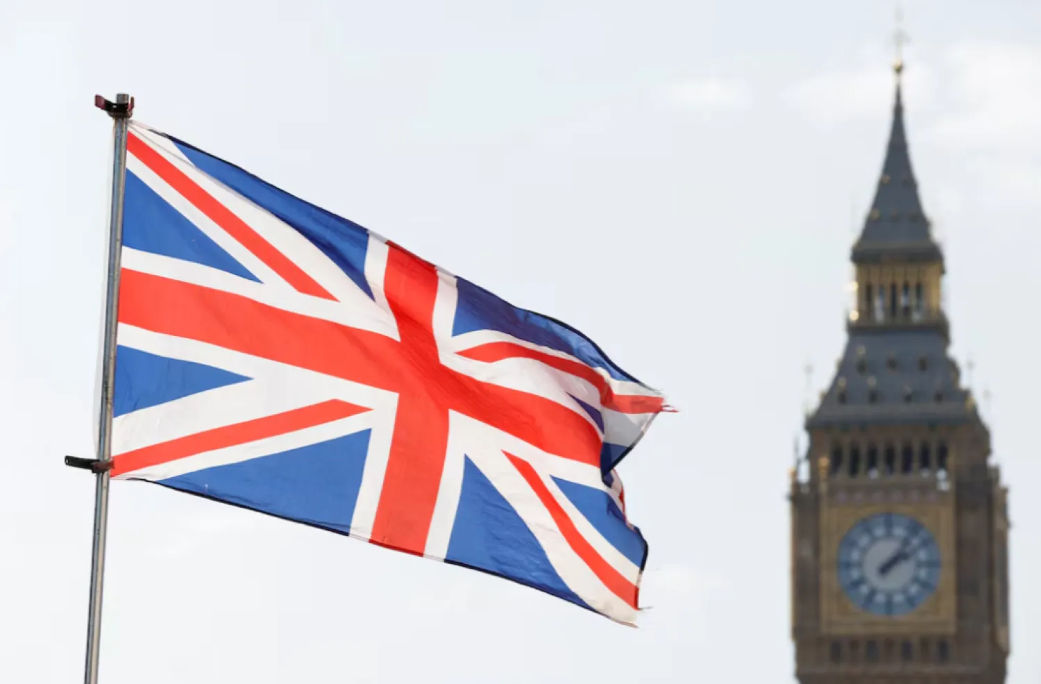 The Britain's national flag flies next to the Elizabeth Tower, commonly known as Big Ben, in London, Britain, March 23, 2022. REUTERS/Peter Cziborra/ File Photo 