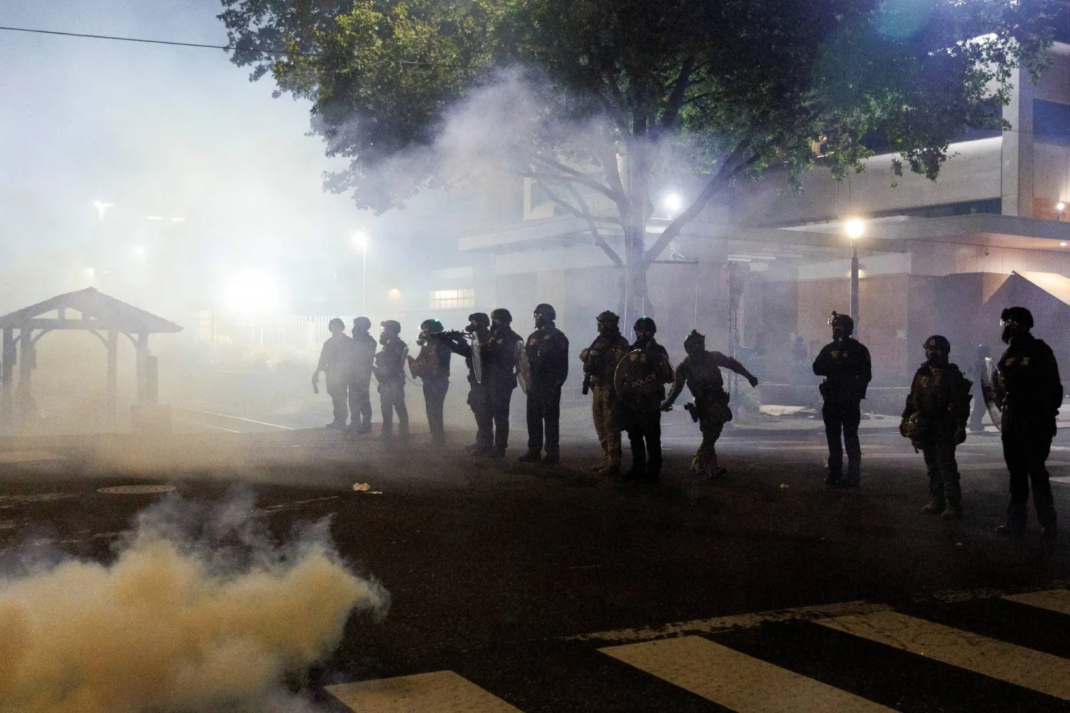 الغاز المسيل للدموع والدخان يتصاعدان مع انتشار عناصر دائرة الهجرة والجمارك الأميركية في أثناء احتجاجات على سياسات الهجرة لإدارة الرئيس دونالد ترمب في بورتلاند - أوريغون (رويترز)