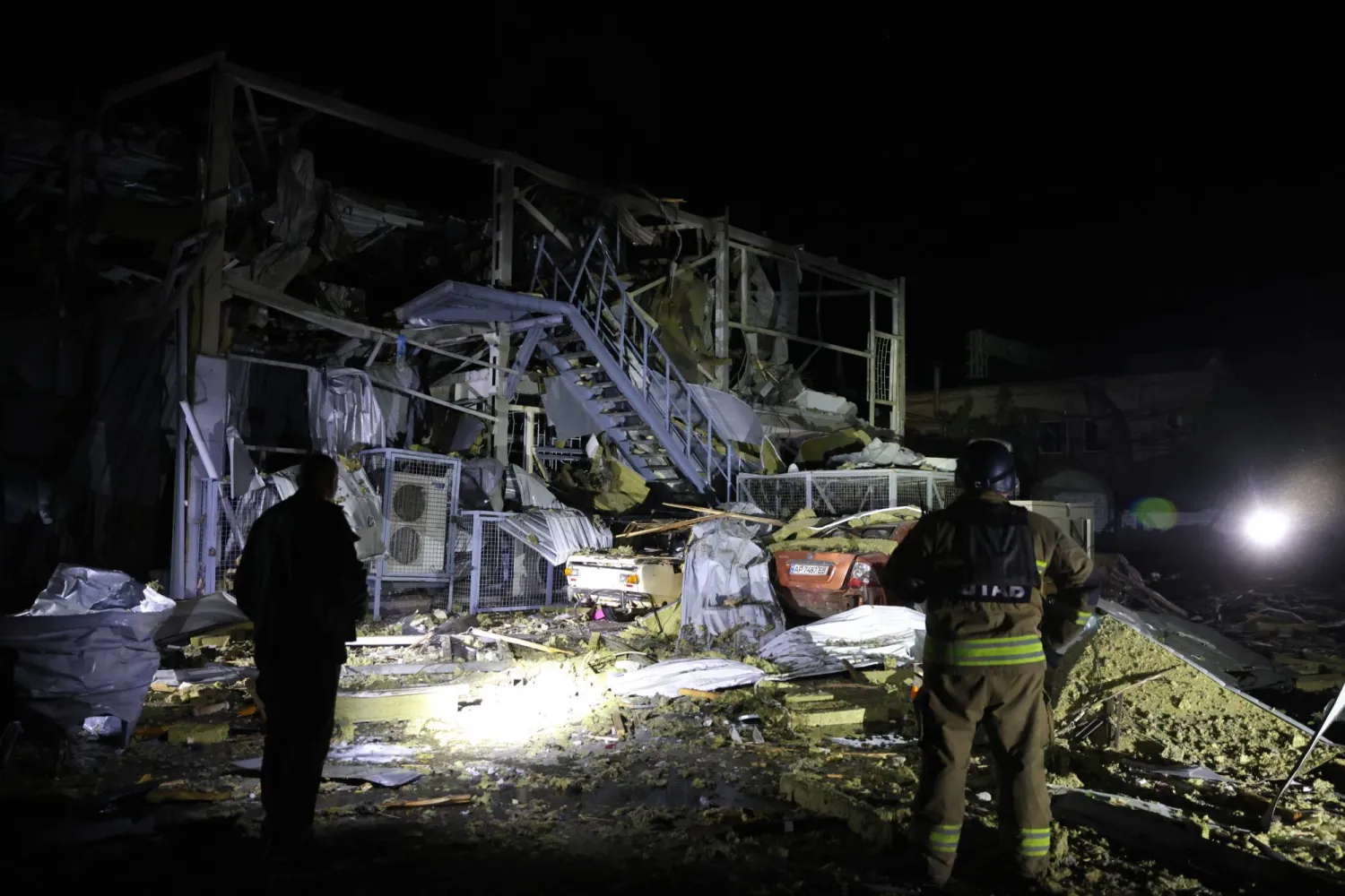 Rescuers work near a destroyed supermarket after a Russian drone strike in Zaporizhzhia, Ukraine, on Saturday, Sept. 27, 2025. (AP Photo/Kateryna Klochko)