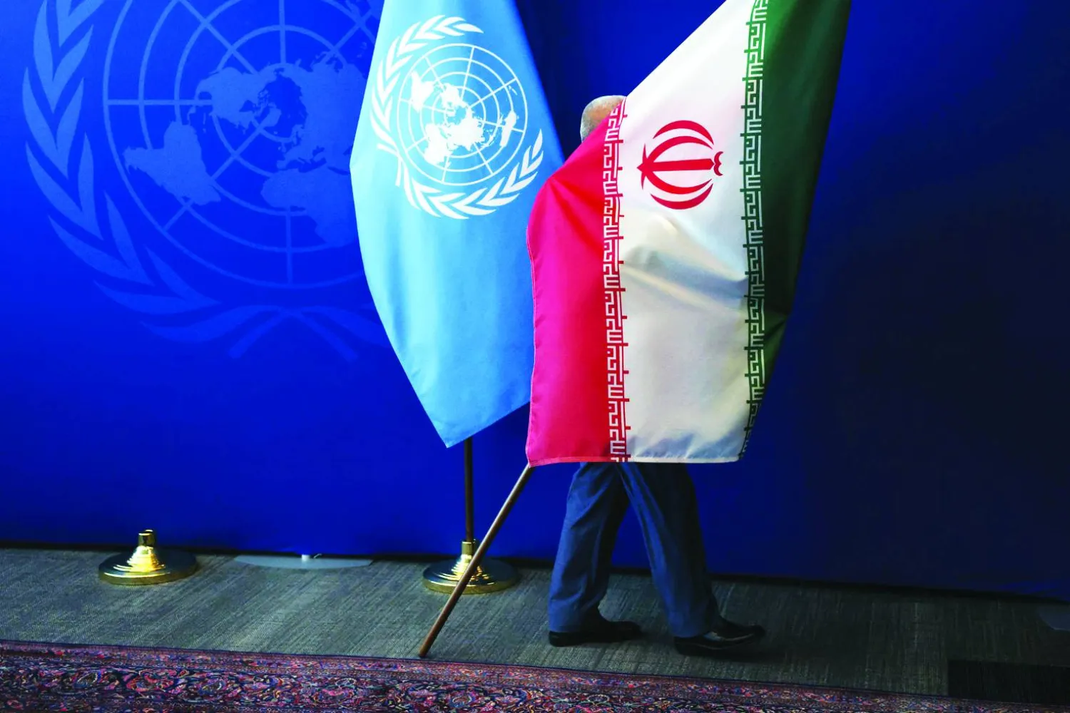 NEW YORK - SEPTEMBER 25: The Iranian flag is taken out of the room after Iranian President Masoud Pezeshkian met with the United Nations (UN) Secretary General Antonio Guterres during the UN's General Assembly on September 25, 2025, in New York City. Spencer Platt/Getty Images/AFP 