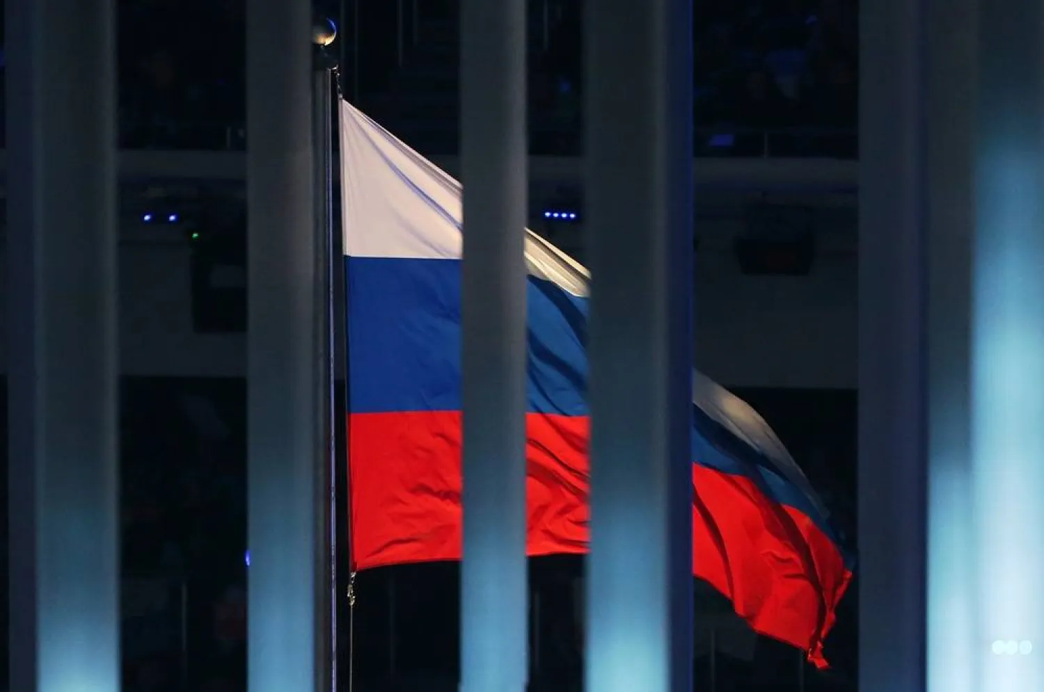 07 March 2014, Russia, Sochi: The Russian flag is pictured behind a fence during the Opening ceremony of the 2014 Winter Paralympics at the Fisht Olympic stadium in Sochi. (dpa)