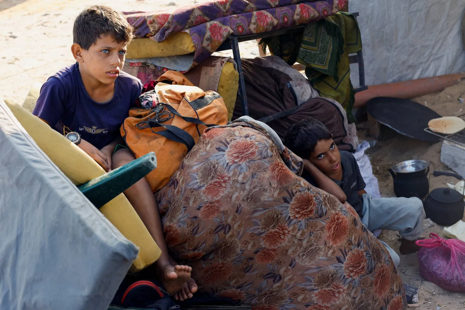 Two Palestinian boys flee with their family from Gaza City toward the south on Saturday (Reuters). 