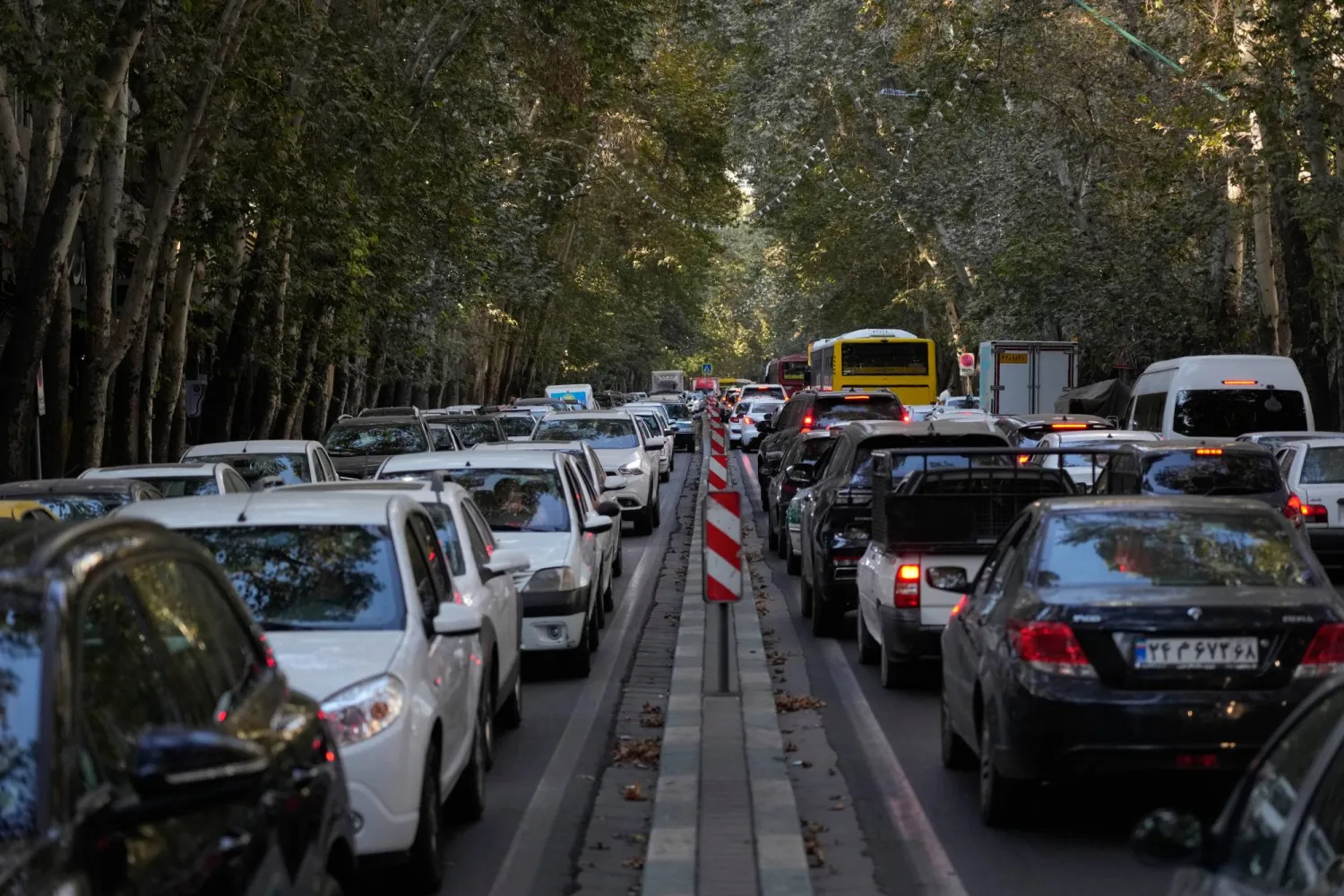 People commute in their cars during an afternoon traffic jam in northern Tehran, Iran, Sunday, Sept. 28, 2025. (AP Photo/Vahid Salemi)