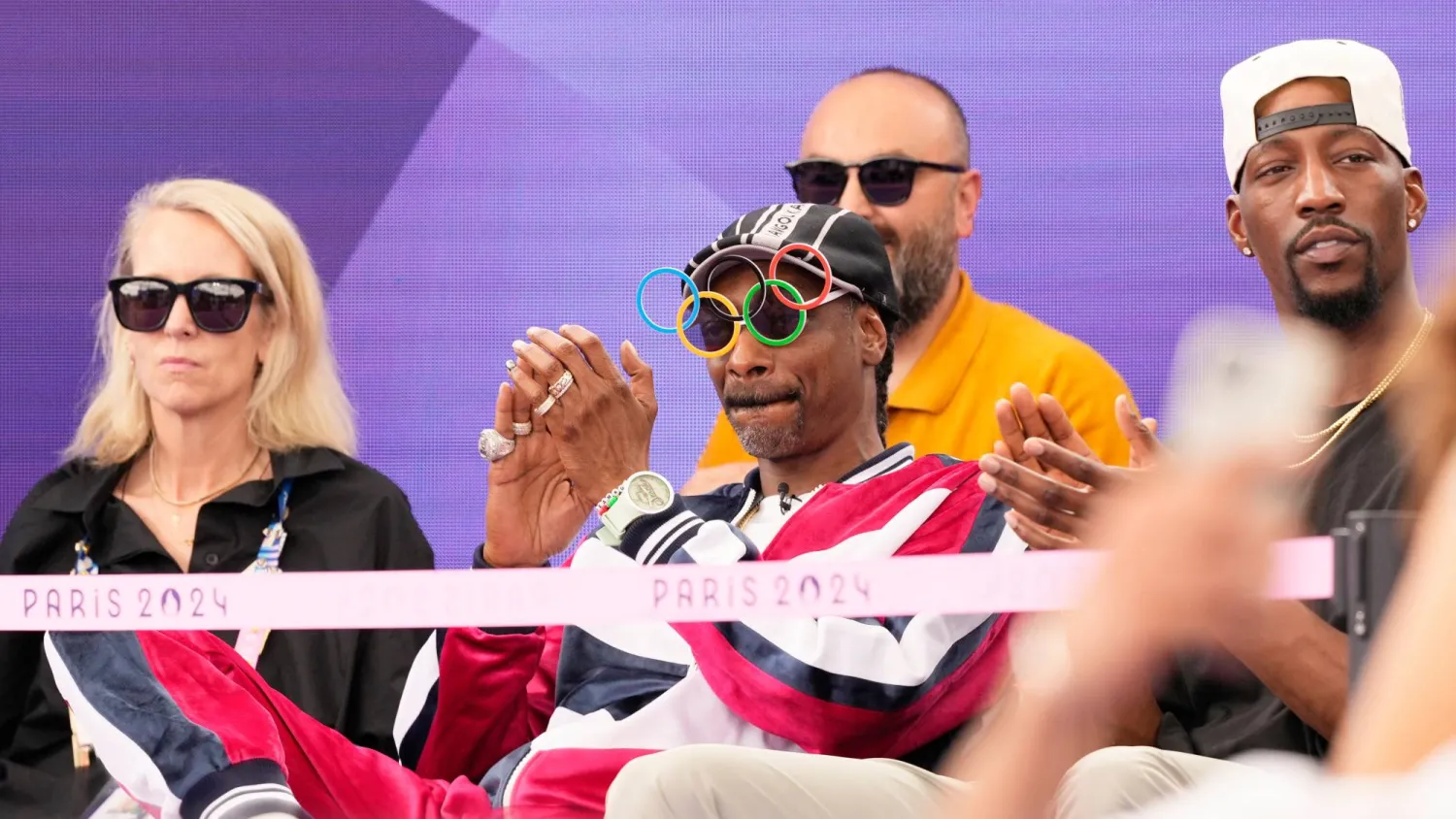 American artist Snoop Dogg, center, sits in the audience prior to the breaking competition at La Concorde Urban Park at the 2024 Summer Olympics, Friday, Aug. 9, 2024, in Paris, France. (AP)