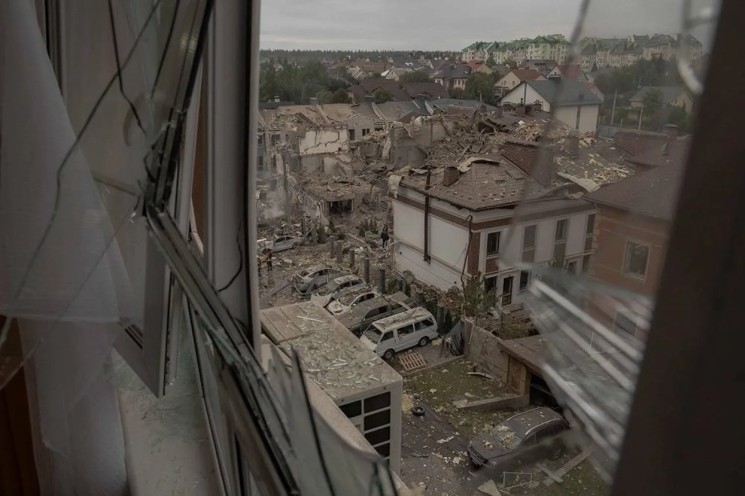 A view through a destroyed window shows the site of heavily damaged residential buildings following a Russian air attack on the outskirts of Kyiv, on September 28, 2025, amid the Russian invasion of Ukraine. (AFP) 