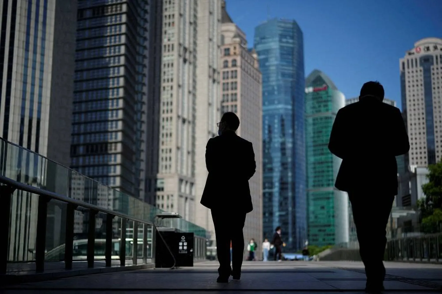 People walk by office towers in the Lujiazui financial district of Shanghai, China October 17, 2022. (Reuters)