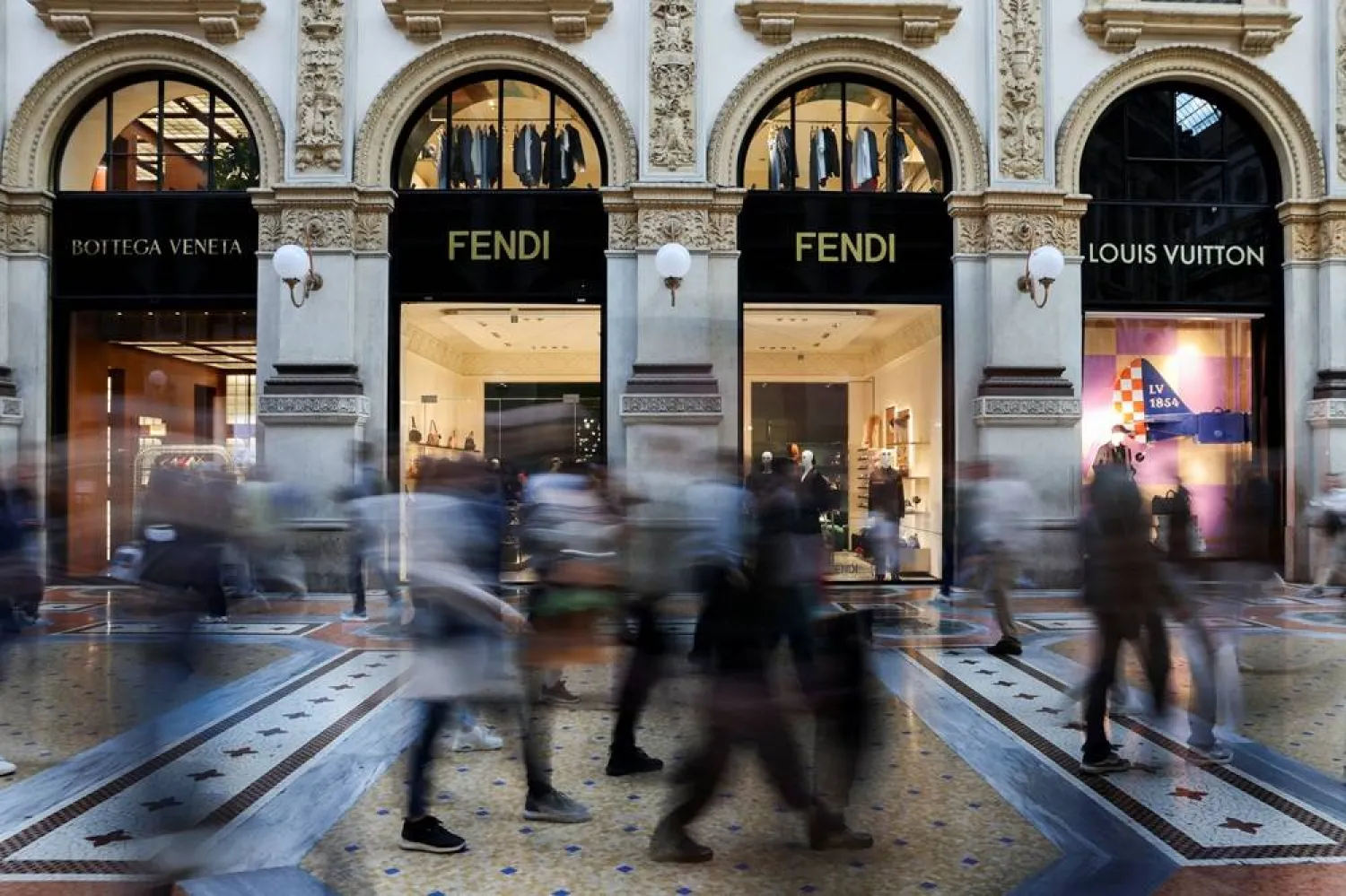  People walk past Bottega Veneta, Fendi and Louis Vuitton stores in Galleria Vittorio Emanuele II, in Milan, Italy, September 27, 2025. (Reuters)
